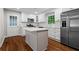 Updated kitchen featuring white cabinets, island, stainless steel appliances, and hardwood floors at 624 Lyle Se Dr, Marietta, GA 30067