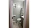 Half bathroom featuring a new toilet, vanity, hardware, shelving, and new paint at 1007 Wayne Dr, Snellville, GA 30078