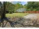 Exterior side view featuring a well-maintained lawn, a manicured landscape, and a wooden fence at 1007 Wayne Dr, Snellville, GA 30078