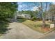 Charming two-story home with well-maintained landscaping and a long driveway in a lush, wooded setting at 1007 Wayne Dr, Snellville, GA 30078