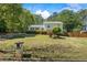 Charming two-story home featuring lush landscaping and a well-manicured lawn with mature trees at 1007 Wayne Dr, Snellville, GA 30078