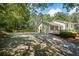 Charming home featuring a welcoming front porch, complemented by a spacious driveway and lush, mature trees at 1007 Wayne Dr, Snellville, GA 30078