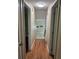 Hallway featuring recently refinished hardwood floors and doors to various rooms in the home at 1007 Wayne Dr, Snellville, GA 30078