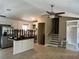 Open kitchen and entrance featuring stainless steel appliances, and a staircase in a neutral color palette at 1007 Wayne Dr, Snellville, GA 30078