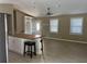 Open living area with new wood floors, a ceiling fan, and a breakfast bar with pendant lighting at 1007 Wayne Dr, Snellville, GA 30078