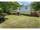 Exterior side view featuring a well-maintained lawn, a manicured landscape, and a wooden fence at 1007 Wayne Dr, Snellville, GA 30078