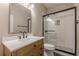 Bathroom featuring modern vanity and walk-in shower with glass doors at 1967 West John Calvin Ave, Atlanta, GA 30337