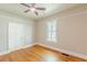 Bright bedroom features hardwood floors, neutral walls, and ceiling fan at 1967 West John Calvin Ave, Atlanta, GA 30337