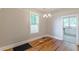 Dining room with chandelier lighting and hardwood floors with large window at 1967 West John Calvin Ave, Atlanta, GA 30337