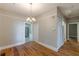 Dining room with chandelier, hardwood floors, and access to the kitchen at 1967 West John Calvin Ave, Atlanta, GA 30337