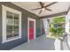 Inviting front porch with ceiling fan and red door at 1967 West John Calvin Ave, Atlanta, GA 30337