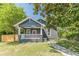 Charming bungalow featuring a covered front porch, fresh lawn and walkway at 1967 West John Calvin Ave, Atlanta, GA 30337