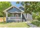 Charming bungalow featuring a covered front porch, fresh lawn and walkway at 1967 West John Calvin Ave, Atlanta, GA 30337
