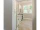 Hallway view of the kitchen's layout, featuring modern appliances and fixtures with a view to the outside at 1967 West John Calvin Ave, Atlanta, GA 30337
