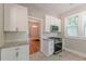 A well-equipped kitchen features white cabinets, stainless steel appliances, and granite countertops adjacent to a dining area at 1967 West John Calvin Ave, Atlanta, GA 30337