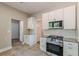 Bright kitchen features white cabinets, stainless steel appliances, and granite countertops. The pantry offers extra storage at 1967 West John Calvin Ave, Atlanta, GA 30337