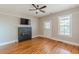 Well lit living room with a fireplace, fan, hardwood floors, and windows at 1967 West John Calvin Ave, Atlanta, GA 30337