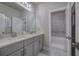 Bathroom with double sink vanity, modern lighting, and a separate tiled shower and bathtub at 2657 Cedar Pine Way, Atlanta, GA 30360