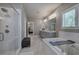 Bathroom with garden tub, glass enclosed shower, marble floors, and double vanity at 2657 Cedar Pine Way, Atlanta, GA 30360