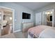 Bedroom with a mounted tv and a view to a large walk-in closet and access to the ensuite bathroom at 2657 Cedar Pine Way, Atlanta, GA 30360