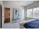 Bedroom with upholstered bench, large art piece, and many windows at 2657 Cedar Pine Way, Atlanta, GA 30360
