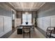 An elegant dining room features wainscoting, modern chandelier, and seating for six at 2657 Cedar Pine Way, Atlanta, GA 30360