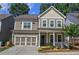 Charming two-story home with a well-manicured front yard and inviting front porch perfect for relaxing at 2657 Cedar Pine Way, Atlanta, GA 30360