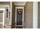 Elegant front door with classic hardware and a seasonal wreath, creating a warm and inviting entrance at 2657 Cedar Pine Way, Atlanta, GA 30360