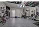 Epoxy floor in garage with overhead storage and exercise equipment at 2657 Cedar Pine Way, Atlanta, GA 30360