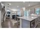 Open-concept kitchen boasts stainless appliances, an island with seating, and sightlines to the living space at 2657 Cedar Pine Way, Atlanta, GA 30360