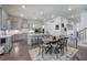 A modern kitchen features gray cabinets, a subway tile backsplash, and a large island with barstool seating at 2657 Cedar Pine Way, Atlanta, GA 30360