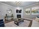 A living room is furnished with a fireplace, contemporary art, and a decorative mirror at 2657 Cedar Pine Way, Atlanta, GA 30360