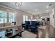 A bright living room includes hardwood floors, lots of natural light, and sleek gray cabinets in the kitchen at 2657 Cedar Pine Way, Atlanta, GA 30360