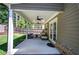 Covered patio with ceiling fans, seating, and a manicured lawn at 2657 Cedar Pine Way, Atlanta, GA 30360