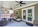 Inviting covered patio features ceiling fans, comfortable seating, and a view of the backyard at 2657 Cedar Pine Way, Atlanta, GA 30360