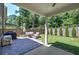 Covered patio with stone flooring, plenty of seating, and a serene backyard view at 2657 Cedar Pine Way, Atlanta, GA 30360