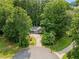 Aerial view of a single-Gathering home with a long private driveway lined with large, mature trees at 2865 Bryant Ct, Cumming, GA 30040