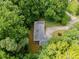 The home has an aerial view of a property that is surrounded by many lush and mature trees at 2865 Bryant Ct, Cumming, GA 30040