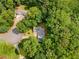 The home has an aerial view of a property with a lot of mature trees and a long private driveway at 2865 Bryant Ct, Cumming, GA 30040