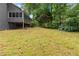 The home features a vast backyard that is surrounded by lush, mature trees and a screened in porch at 2865 Bryant Ct, Cumming, GA 30040