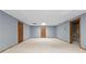 Unfinished basement with neutral carpeting and several wood paneled doors at 2865 Bryant Ct, Cumming, GA 30040