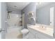Bathroom with tub-shower combination, white tile surround and matching sink at 2865 Bryant Ct, Cumming, GA 30040