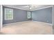 Carpeted bedroom with two windows providing natural light and gray walls at 2865 Bryant Ct, Cumming, GA 30040
