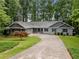 Charming single-Gathering home with well-manicured lawn, mature trees, and a long private driveway at 2865 Bryant Ct, Cumming, GA 30040