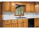 Kitchen featuring wooden cabinets, white countertops, stainless steel sink, and a window view to the outside at 2865 Bryant Ct, Cumming, GA 30040