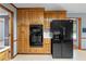 Well-equipped kitchen with wooden cabinets, double wall oven, and modern black refrigerator at 2865 Bryant Ct, Cumming, GA 30040