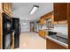 Spacious kitchen area with wooden cabinets, black appliances, and access to a bright breakfast nook at 2865 Bryant Ct, Cumming, GA 30040