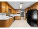 Functional kitchen with wooden cabinets, white countertops, tile backsplash, and modern appliances at 2865 Bryant Ct, Cumming, GA 30040