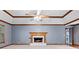 Inviting living room featuring a fireplace, vaulted ceilings with decorative trim and a ceiling fan at 2865 Bryant Ct, Cumming, GA 30040
