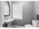 Clean powder room with pedestal sink, window, and commode at 2865 Bryant Ct, Cumming, GA 30040
